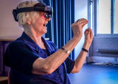 An old person using a Hololens headset.