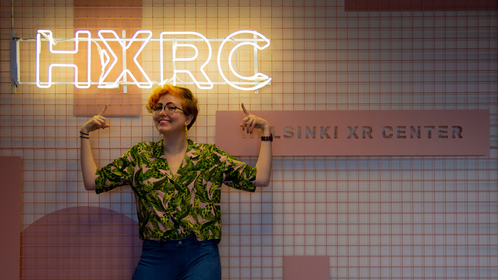 Kira Katve Vesikko in front of the Helsinki XR Center sign