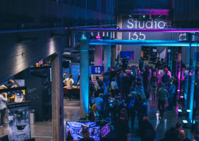 A high-angle view from an event, coloured with neon lights.